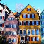 Vibrant facades of traditional houses in Tübingen's historic center, under a clear daytime sky.